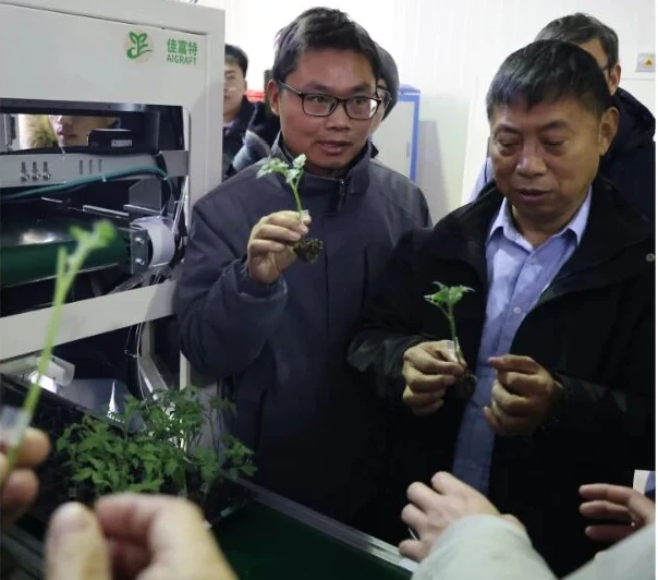AiGRAFT team discussing nursery automation solutions with industry visitors
